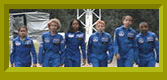 The FETCHers in blue astronaut training jumpsuits.