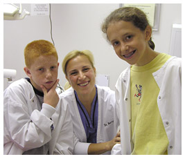 Brian, Anna, and a dentist in white lab coats.
