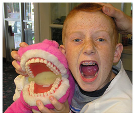 Brian cheek to cheek with a dentist's mouth model.