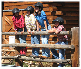 FETCHers at the dude ranch gathered around a corral.