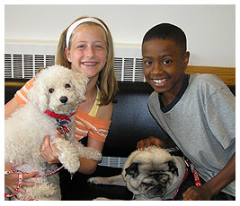 Madi and Mike posing with two therapeutic dogs.