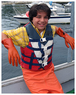 Rosario wearing a rubber jumpsuit and gloves for the lobstering challenge.