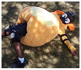 Mike laying flat on the ground wearing his Ruff suit.