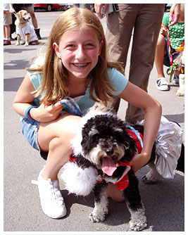 Madi with a dog wearing the outfit she designed.
