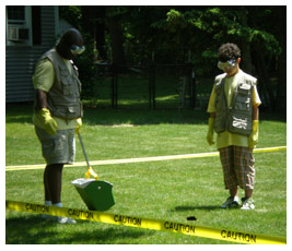 Sterling helps clean up a lawn marked off with caution tape.