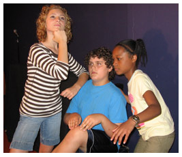 Liza, Brian, and Bethany pose like statues.