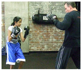 Shreya practices boxing with a boxing instructor.