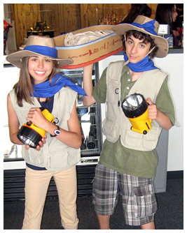 Rubye and Marco hold big flashlights.