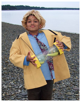Marc holds a giant hourglass and wears a blond wig.