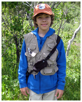 Jay stands in a forest.