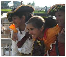 Shreya, Rubye, and Marc wear pirate costumes.