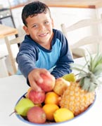 Boy reaching for fruit