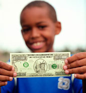 Boy holding million dollar bill