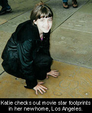 Katie checks out movie star footprints in her new home, Los Angeles.