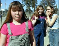 Girls making fun of another