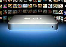 Apple TV hardrive in front of TVs