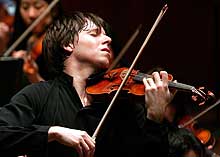 Joshua Bell performs with his violin in concert