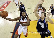 Stephen Jackson is about to score against Dirk Nowitzki.