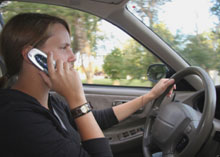 Photo of a teen driving with a cell phone