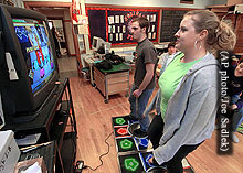 A boy and girl work out to Dance Dance Revolution in health class