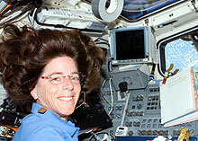 Astronaut Barbara Morgan mans the controls inside the space shuttle