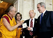 Photo of Dalai Lama receiving a gold medal from President Bush