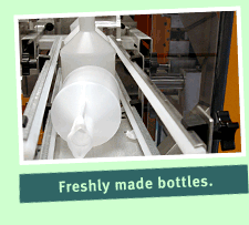 Blow molded plastic bottles after forming and cooling.